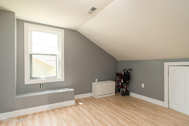 6321 Albatross Dr, New Bern, NC 28560 - additional living space with light wood-style flooring, lofted ceiling, healthy amount of natural light, and baseboards