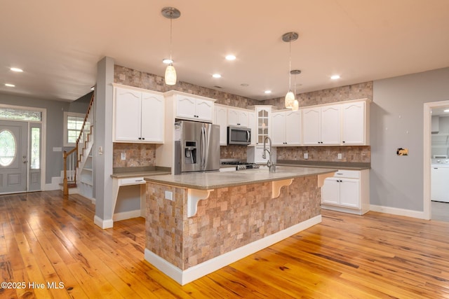 6321 Albatross Dr, New Bern, NC 28560 - kitchen featuring appliances with stainless steel finishes, light wood finished floors, white cabinets, baseboards, and recessed lighting