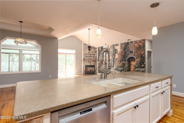 6321 Albatross Dr, New Bern, NC 28560 - kitchen featuring stainless steel dishwasher, open floor plan, a fireplace, a sink, and light wood-style floors