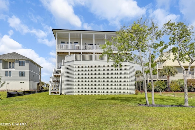 1519 New River Inlet Rd, North Topsail Beach, NC 28460 - back of property with board and batten siding, a porch, a yard, a balcony, and stairs