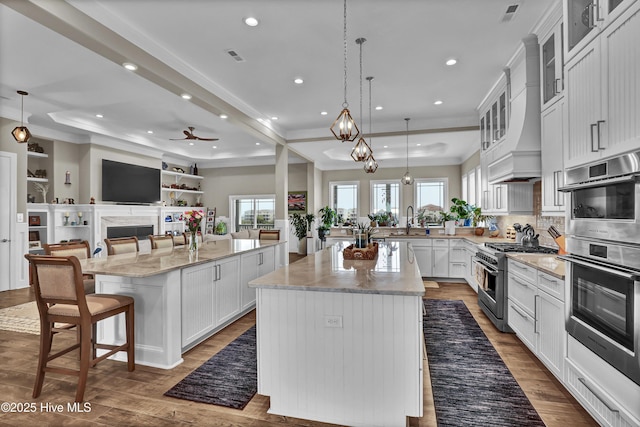 1519 New River Inlet Rd, North Topsail Beach, NC 28460 - kitchen featuring a raised ceiling, open floor plan, dishwasher, and a sink