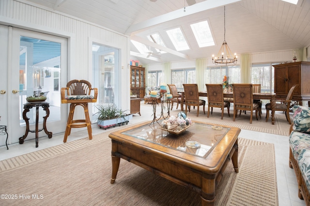 42 Brite Ln, Oriental, NC 28571 - living room featuring vaulted ceiling with skylight, a notable chandelier, and light tile patterned flooring