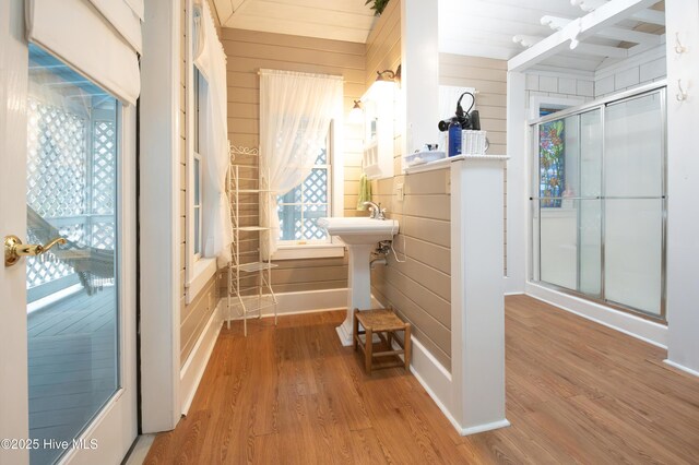 42 Brite Ln, Oriental, NC 28571 - bathroom with a shower with shower door, wood walls, and wood finished floors