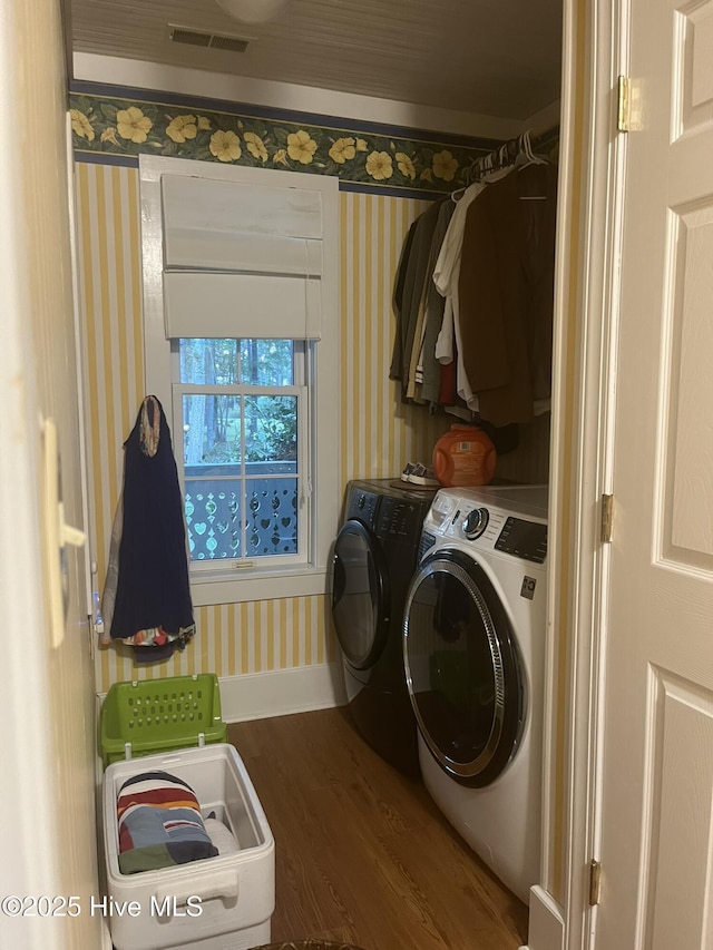42 Brite Ln, Oriental, NC 28571 - clothes washing area featuring separate washer and dryer, wallpapered walls, and wood finished floors