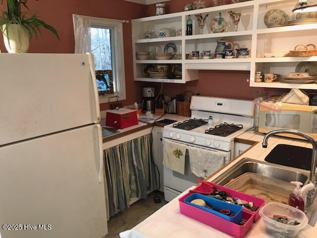 42 Brite Ln, Oriental, NC 28571 - kitchen featuring a sink, open shelves, and white appliances