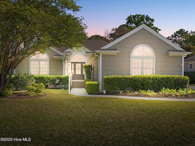 ranch-style house featuring french doors and a front yard