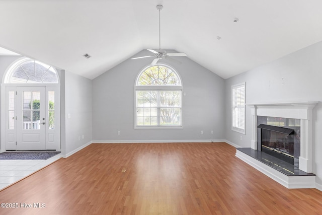 unfurnished living room with a wealth of natural light and light wood-style floors