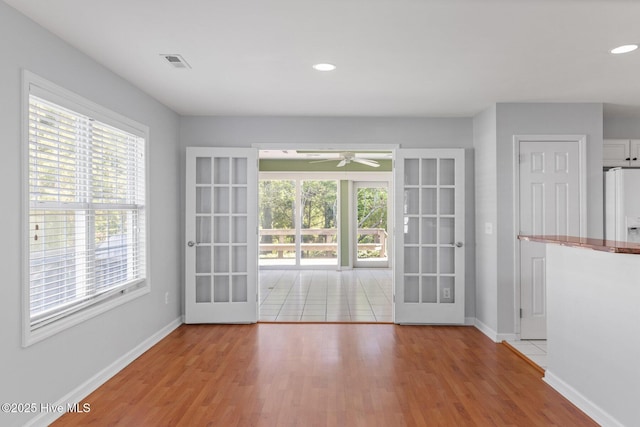 doorway to outside with french doors, visible vents, ceiling fan, and baseboards
