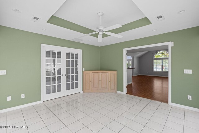 spare room featuring french doors, ceiling fan, visible vents, and baseboards