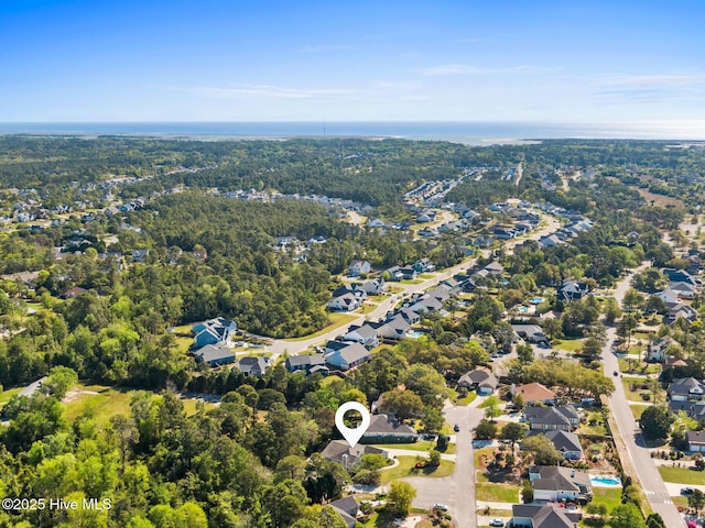 bird's eye view featuring a wooded view and a residential view