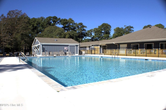 pool featuring a patio area and fence