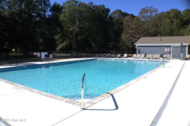 pool featuring fence and a patio