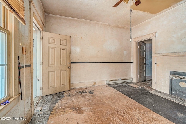 304 Ambler Ave, Rocky Mount, NC 27801 - unfurnished room with ornamental molding, a ceiling fan, a baseboard heating unit, and a brick fireplace