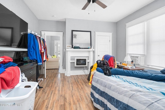 304 Ambler Ave, Rocky Mount, NC 27801 - bedroom with ceiling fan, light wood finished floors, cooling unit, and a fireplace