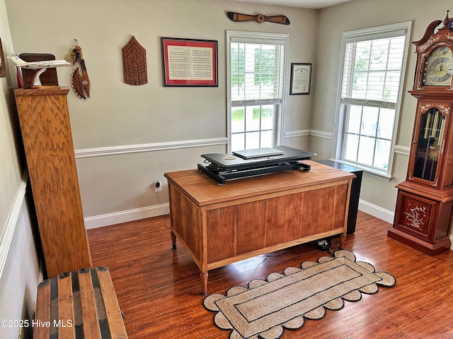 office with baseboards, dark wood-type flooring, and a wealth of natural light