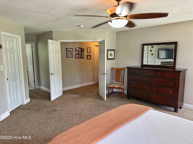 carpeted bedroom with baseboards, a ceiling fan, and a textured ceiling