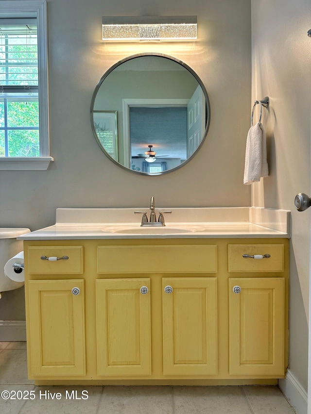bathroom featuring baseboards, ceiling fan, and vanity