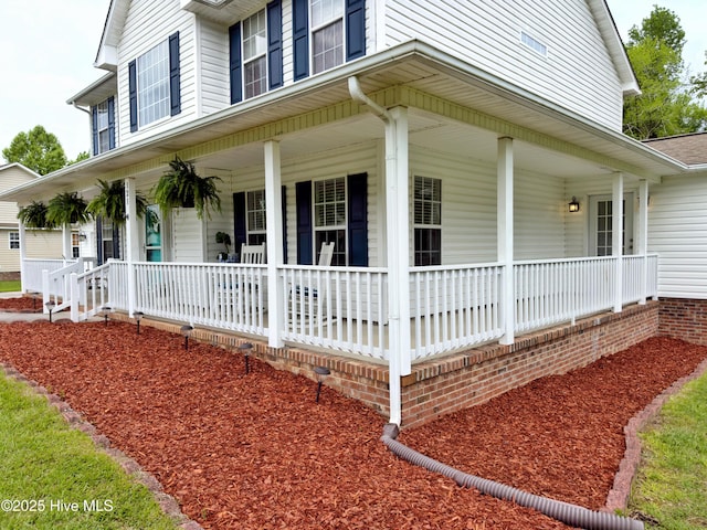 view of side of property featuring a porch