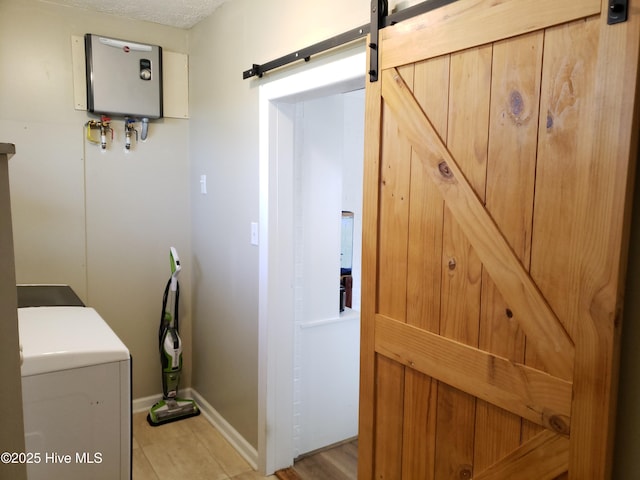 504 E S St, Fremont, NC 27830 - laundry room with a barn door, water heater, and baseboards