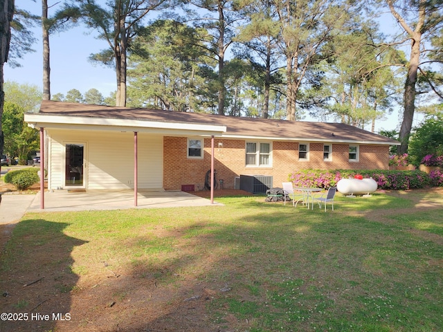 504 E S St, Fremont, NC 27830 - rear view of house with brick siding, a yard, and a patio area