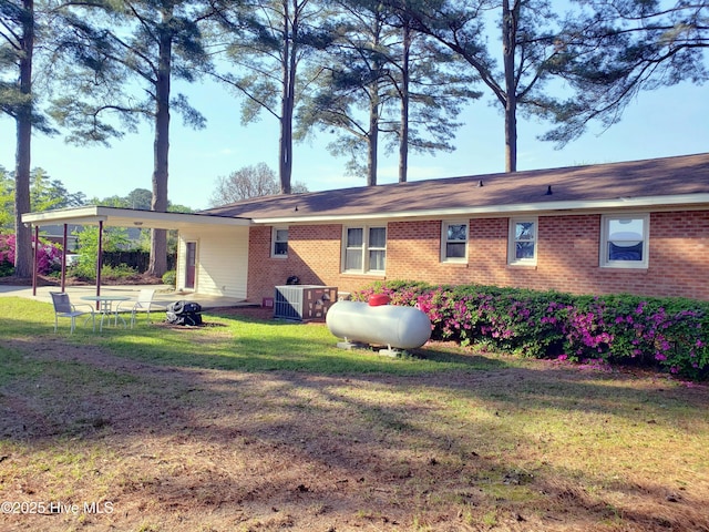 504 E S St, Fremont, NC 27830 - back of property with a lawn, central AC unit, and brick siding
