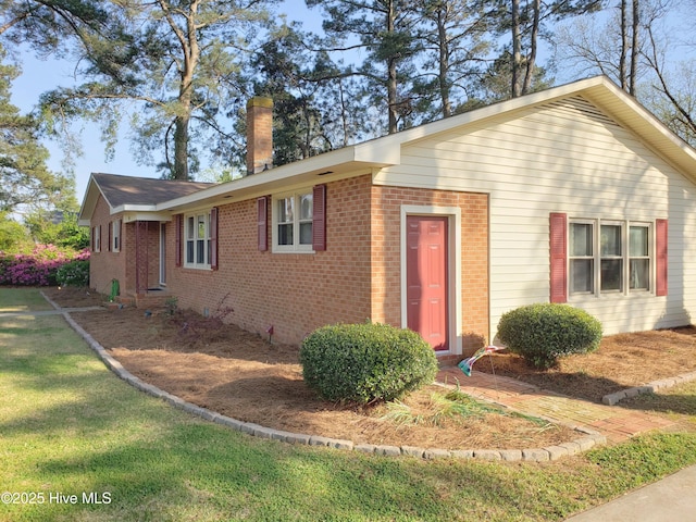 504 E S St, Fremont, NC 27830 - ranch-style house featuring a chimney, brick siding, and a front yard