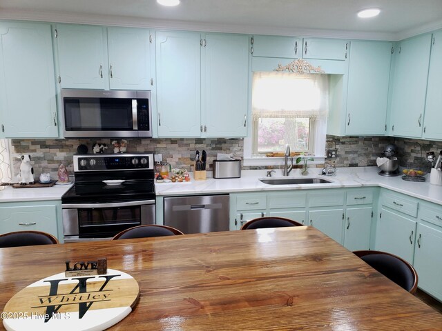 504 E S St, Fremont, NC 27830 - kitchen with stainless steel appliances, a sink, tasteful backsplash, and recessed lighting