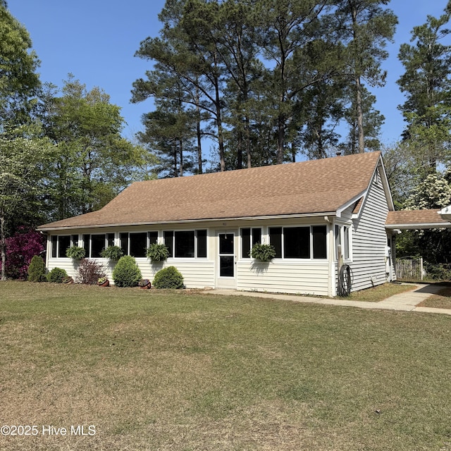 501 Blackfoot Trl, Edenton, NC 27932 - view of front of home with a shingled roof, a front yard, and a carport