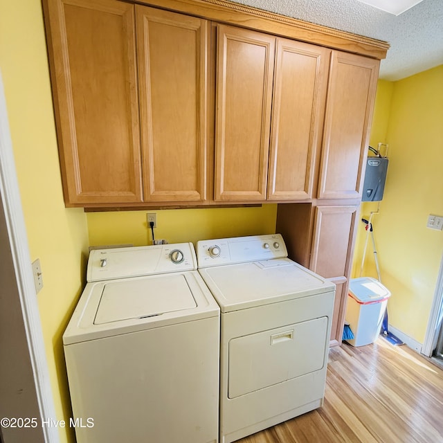 501 Blackfoot Trl, Edenton, NC 27932 - laundry area featuring light wood-style floors, baseboards, separate washer and dryer, cabinet space, and a textured ceiling