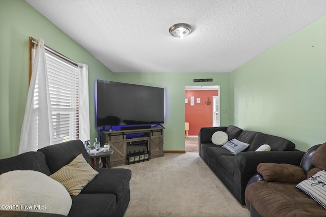 carpeted living room featuring a textured ceiling