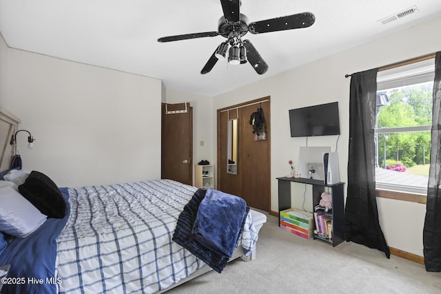bedroom featuring a ceiling fan, visible vents, and carpet