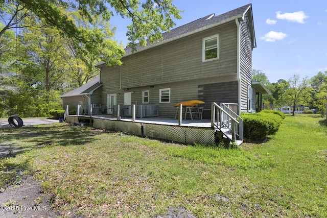 rear view of property with a lawn and a wooden deck