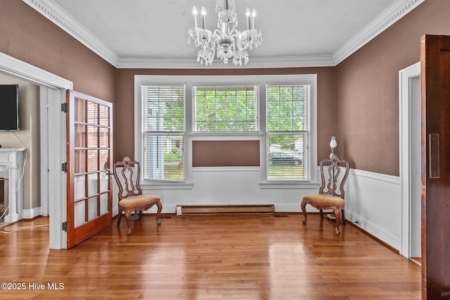 306 N Parker St, Elm City, NC 27822 - sitting room with a baseboard heating unit, wood finished floors, an inviting chandelier, and crown molding