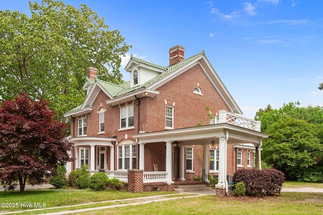 306 N Parker St, Elm City, NC 27822 - view of front of house with a ceiling fan, a chimney, covered porch, brick siding, and a front yard