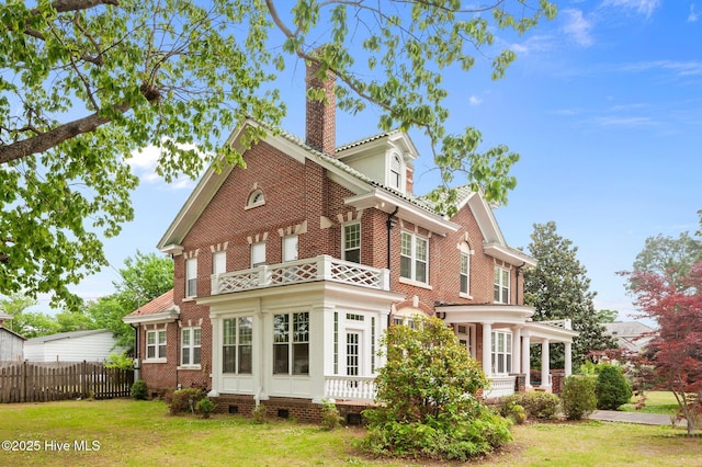306 N Parker St, Elm City, NC 27822 - exterior space with a balcony, a chimney, fence, a yard, and brick siding