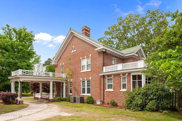 306 N Parker St, Elm City, NC 27822 - view of side of home with a chimney, central AC unit, a balcony, a gazebo, and brick siding