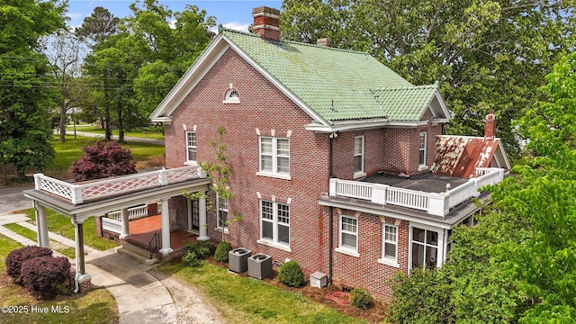 306 N Parker St, Elm City, NC 27822 - view of side of home featuring central air condition unit, driveway, a chimney, brick siding, and a balcony