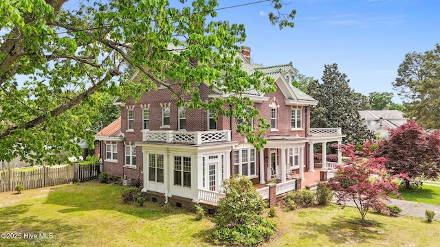 306 N Parker St, Elm City, NC 27822 - back of house featuring fence, a chimney, brick siding, and a yard