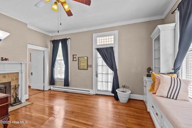 306 N Parker St, Elm City, NC 27822 - living area with light wood finished floors, baseboard heating, ornamental molding, and ceiling fan