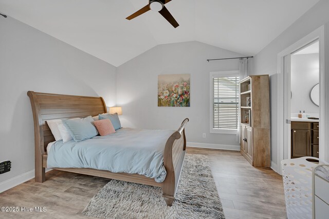 bedroom with baseboards, light wood finished floors, ceiling fan, and lofted ceiling