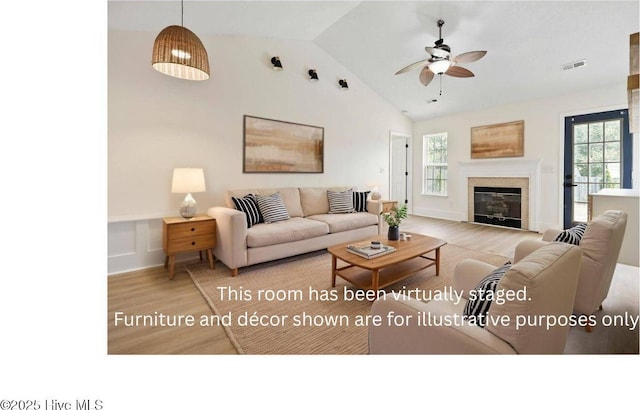 711 Glenarthur Dr, Wilmington, NC 28412 - living room featuring wood finished floors, ceiling fan, a glass covered fireplace, and high vaulted ceiling