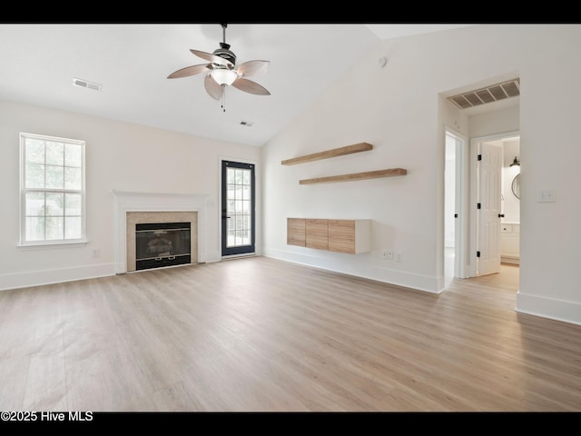 711 Glenarthur Dr, Wilmington, NC 28412 - unfurnished living room with ceiling fan, light wood-style flooring, a premium fireplace, baseboards, and high vaulted ceiling