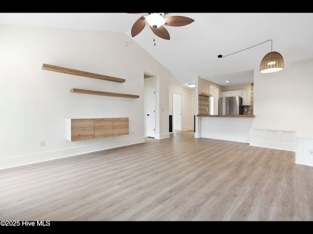 711 Glenarthur Dr, Wilmington, NC 28412 - unfurnished living room featuring a ceiling fan, light wood-type flooring, lofted ceiling, and baseboards