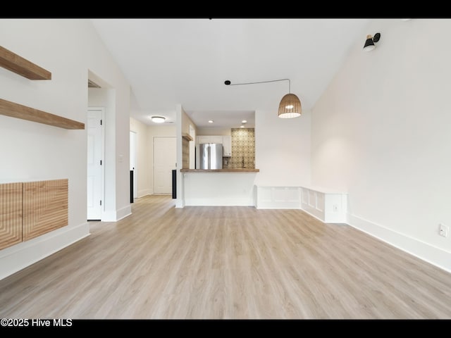 711 Glenarthur Dr, Wilmington, NC 28412 - unfurnished living room with light wood-type flooring and baseboards