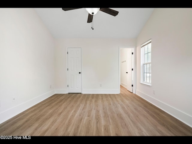 711 Glenarthur Dr, Wilmington, NC 28412 - spare room with vaulted ceiling, a ceiling fan, wood finished floors, and baseboards