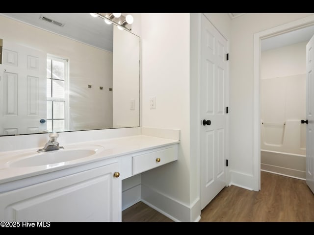 711 Glenarthur Dr, Wilmington, NC 28412 - full bathroom with wood finished floors, vanity, and baseboards