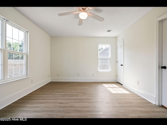 711 Glenarthur Dr, Wilmington, NC 28412 - empty room featuring plenty of natural light, light wood-type flooring, a ceiling fan, and baseboards