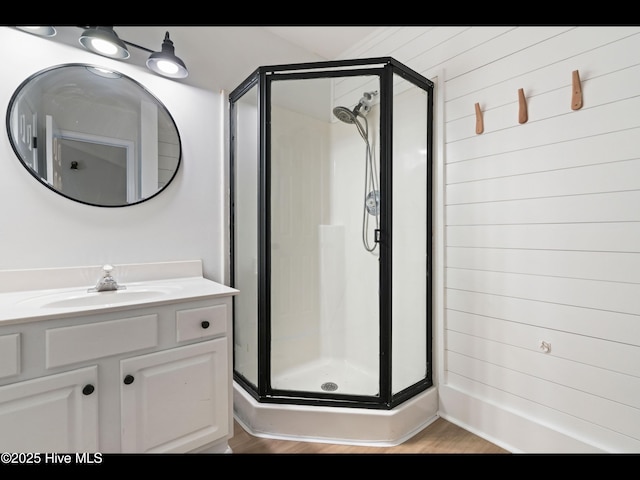 711 Glenarthur Dr, Wilmington, NC 28412 - bathroom with a stall shower, vanity, and wood finished floors