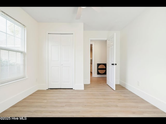 711 Glenarthur Dr, Wilmington, NC 28412 - unfurnished bedroom with light wood-style floors, baseboards, a closet, and ceiling fan