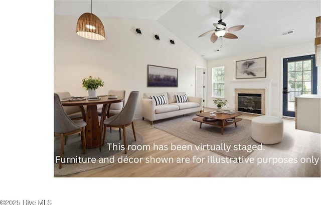 711 Glenarthur Dr, Wilmington, NC 28412 - living room featuring wood finished floors, ceiling fan, a glass covered fireplace, and high vaulted ceiling